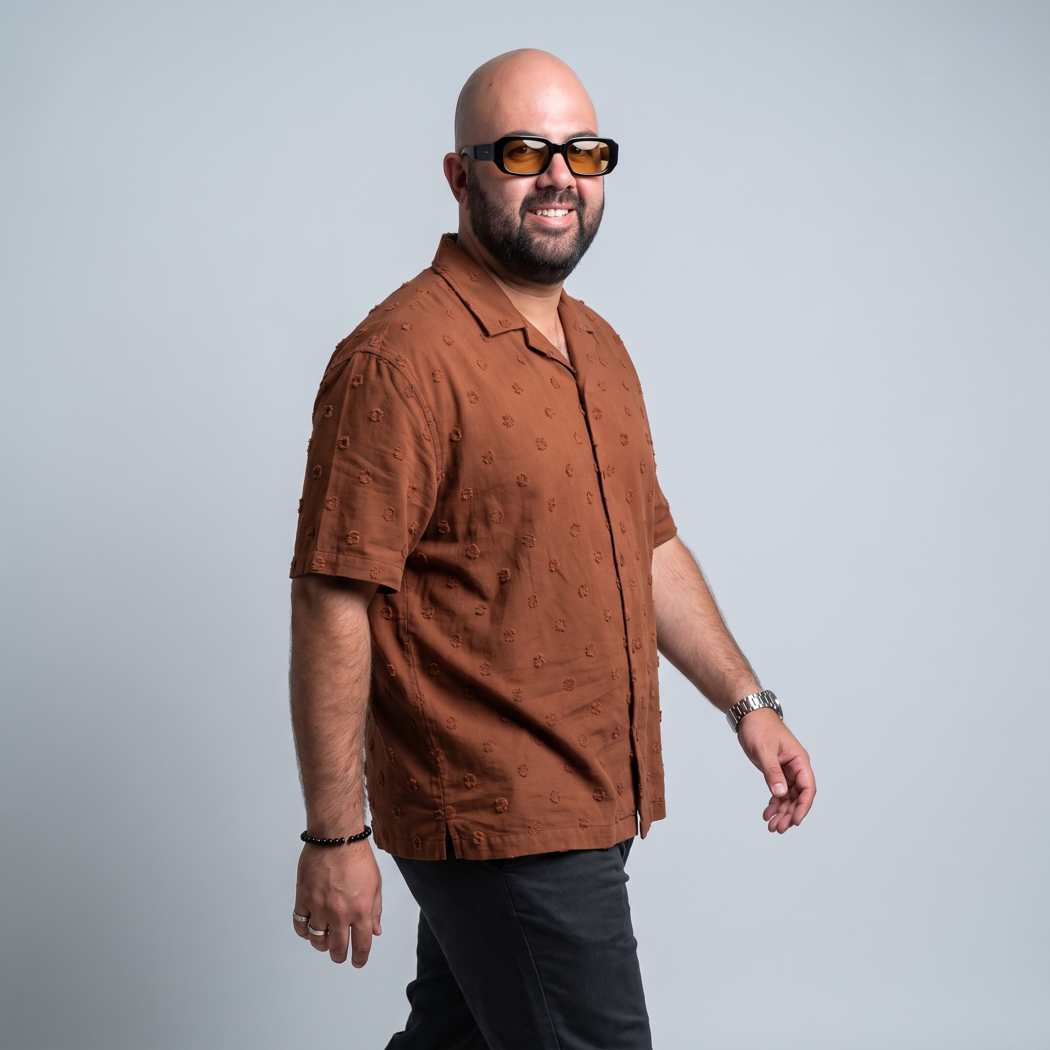 BerGi Dj de pie, con gafas y camisa color teja